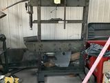 a picture of a garage with a large metal frame and tools