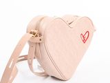 beige heart shaped bag with a red heart on the side