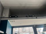 three lights that are on the ceiling above a window