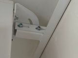 a white toilet in the corner of a bathroom