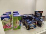 several boxes of tea sit on a counter in front of a refrigerator