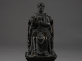 a bronze statue of a woman sitting on a throne