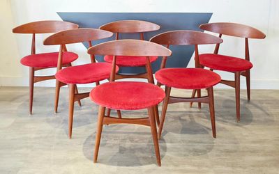 six red chairs sitting in a row on the floor