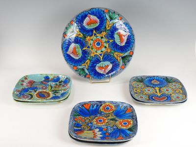 several plates and trays are sitting on a white surface