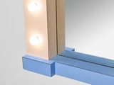 a mirror that has lights on it in front of a mirror