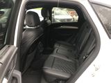 the back seats of a car with the door open and the driver ' s seat down