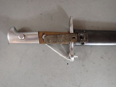 a knife with a wooden handle on a white surface