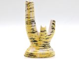 a yellow vase with a black and white design on it