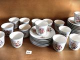a lot of cups and saucers on the table