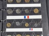 a black binder with a bunch of coins in it