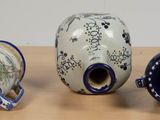 three vases sitting on a table next to each other