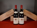 two bottles of wine sitting next to each other on a table