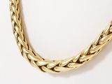an image of a gold necklace on a white background