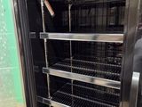 an image of a refrigerator with many racks of food inside of it