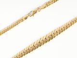 a close up of a gold chain on a white background