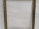 a gold picture frame with a white background