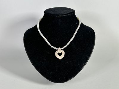 a close up of a necklace on a mannequin display