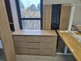 an image of a room with a desk and a window