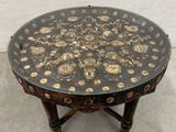 a black and gold table with a flower design on it