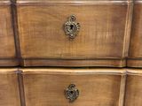 a wooden dresser with two drawers on top of it
