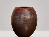 a brown vase that is sitting on a table