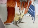 a close up of a vase with a painting on it