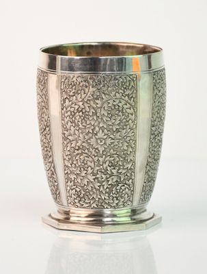 a silver cup that is sitting on a table