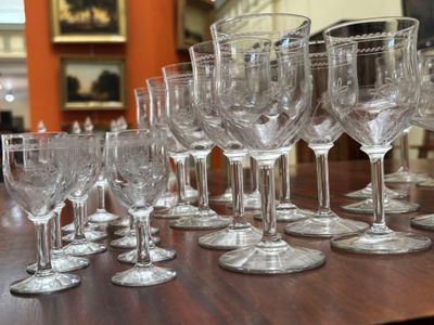 many wine glasses lined up on a table