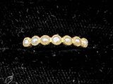 a close up of a gold ring with pearls on it