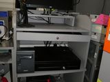 a computer desk with a monitor and a printer on top of it