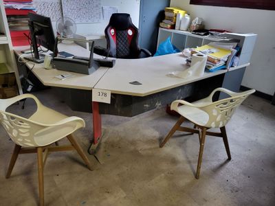 a desk with two chairs and a computer on top of it