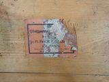 a label on a piece of wood that is peeling off