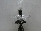 a glass bowl with a bird on top of it
