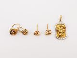 three pairs of gold earrings and a pendant