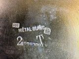 a close up of a metal bowl with a label on it