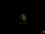 a black background with a green and red ring in the middle of it