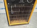 a close up of a yellow and black heater on a table