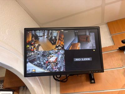 a television mounted on the wall with a picture on it