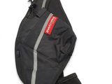 the back of a black backpack with a red tag on it