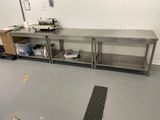 a kitchen with a metal counter and a metal sink