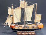 a model of a sailboat on a wooden stand