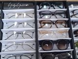 many pairs of glasses sitting in a display case