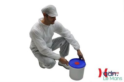 man in white coverall painting a bucket with a blue lid
