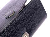 a black leather wallet with a metal button on it