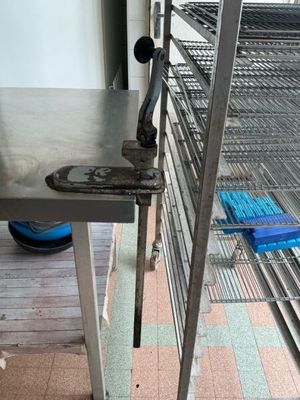 a metal table that is on a shelf in a room