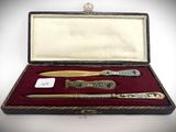 a box with a pen, knife, and other items in it