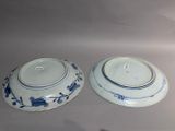 pair of blue and white porcelain bowls with blue flowers on them