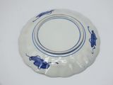 a blue and white plate on a white table