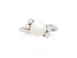 a white pearl and diamond ring on a white background