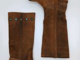 a pair of brown boots sitting on top of a white surface